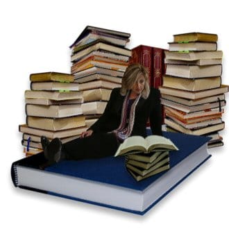 Me, sitting on a pile of very large books.